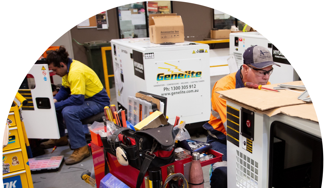 two men working on generators